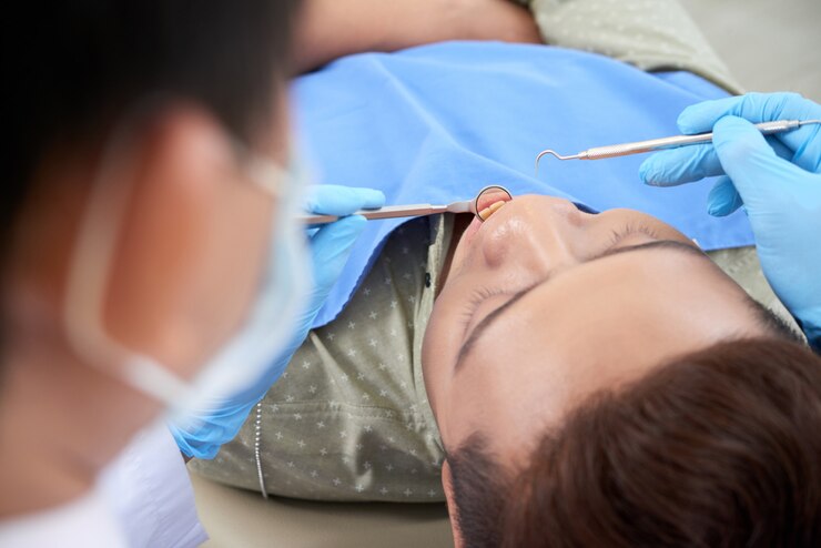 asian-male-patient-having-dental-checkup-clinic_1098-20353