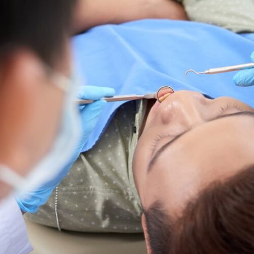 asian-male-patient-having-dental-checkup-clinic_1098-20353