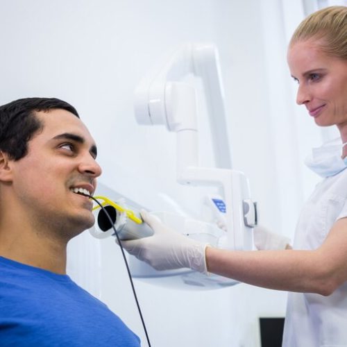 dentist-taking-male-patients-tooth-x-ray_107420-73935