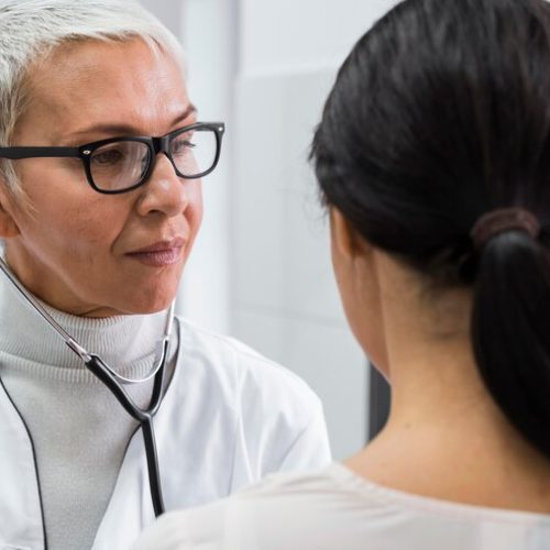 doctor-using-stethoscope-female-patient_23-2148757400