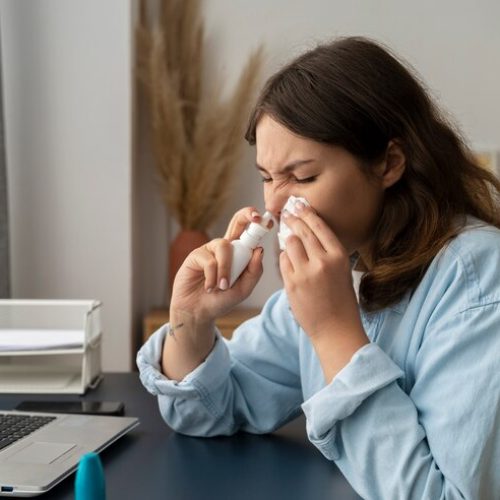 woman-holding-nasal-spray-side-view_23-2149640411